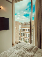 a bed sitting in a bedroom next to a window