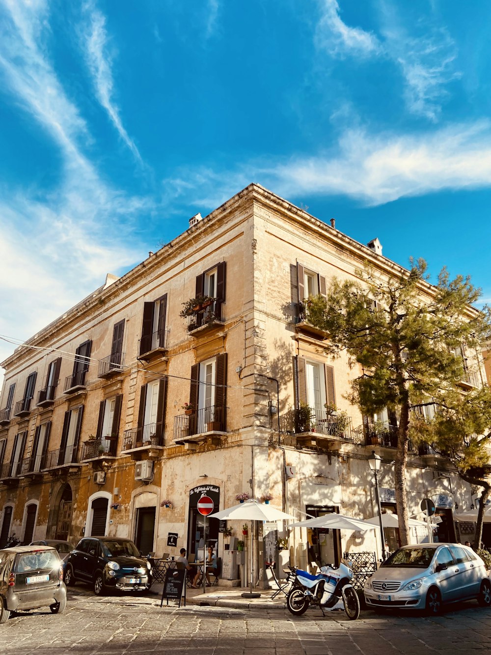 a street corner with cars parked in front of a building