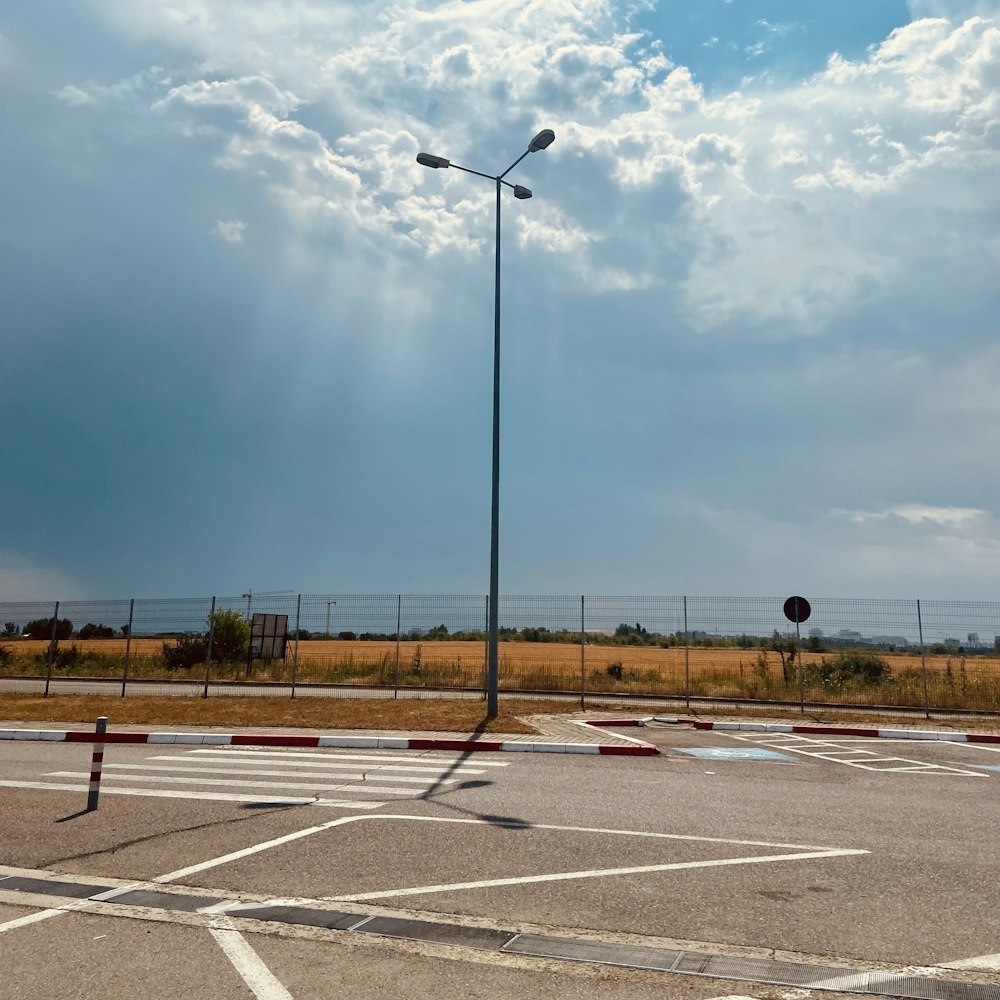 an empty parking lot with a street light