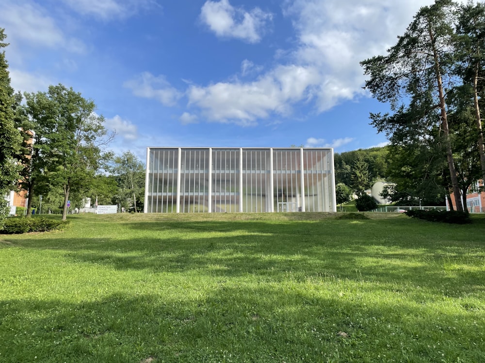 a large building sitting on top of a lush green field