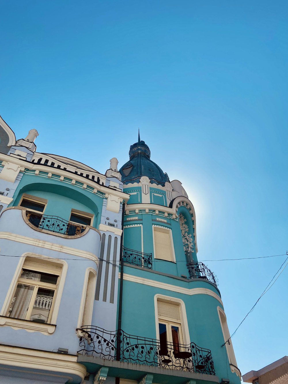 a blue and white building with a blue sky in the background