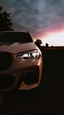A sleek camera setup capturing a dynamic automotive scene at dusk.
