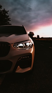 A sleek camera setup capturing a dynamic automotive scene at dusk.