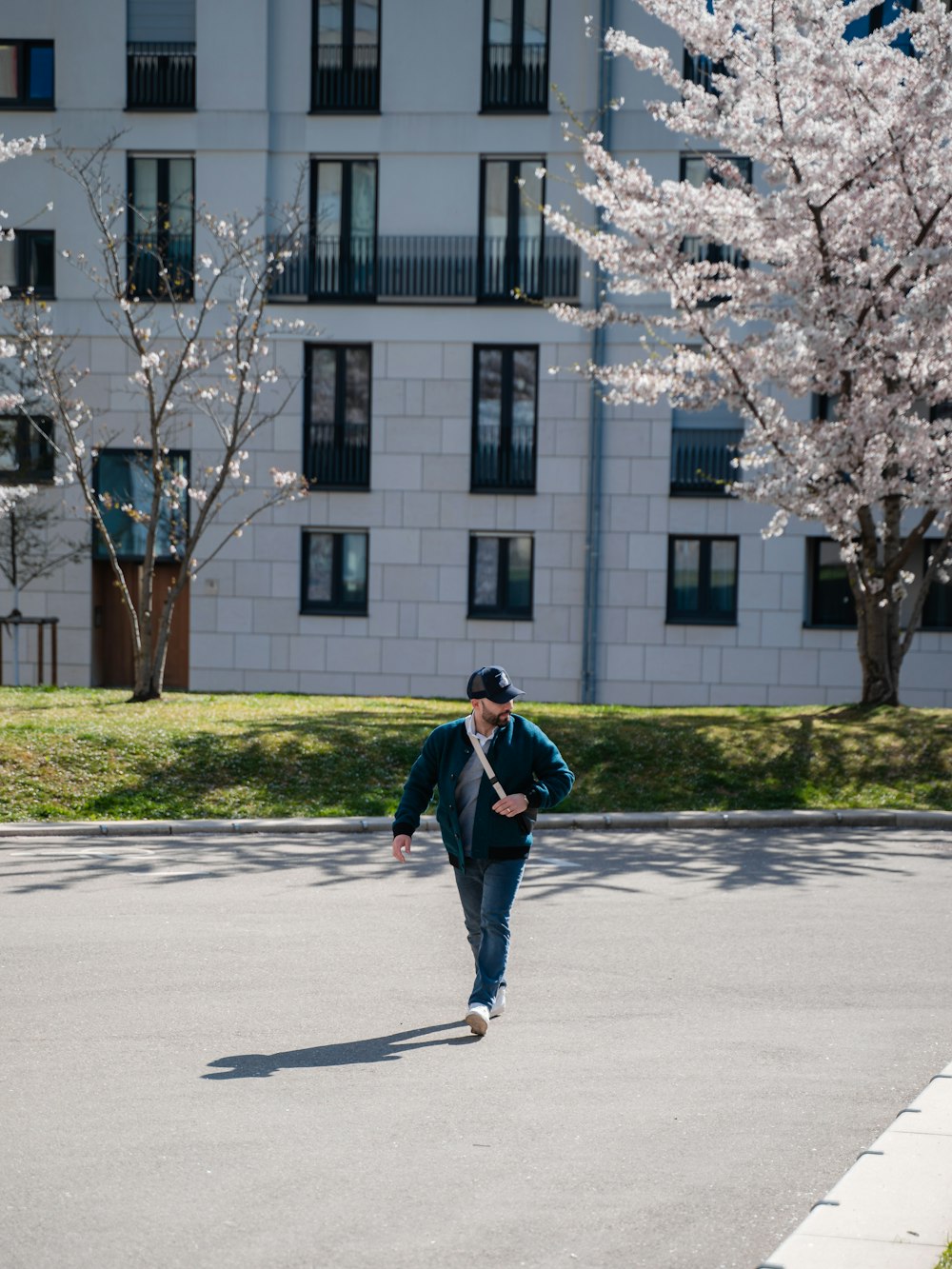 a man walking down the street in front of a building