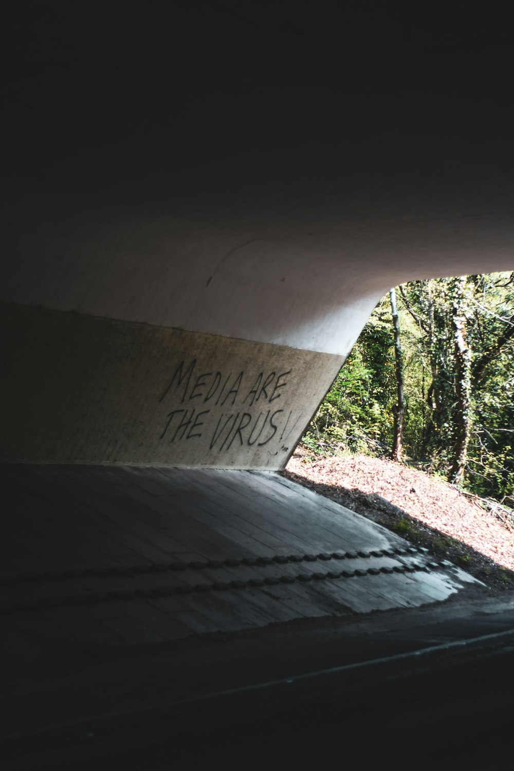 a tunnel with graffiti on the side of it