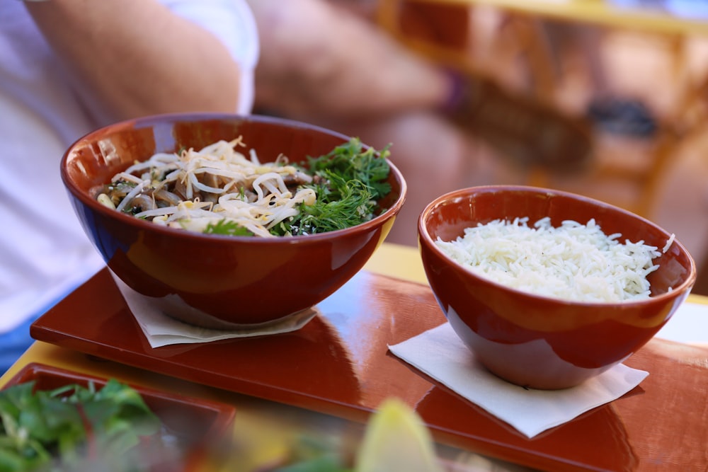 a couple of bowls of food on a table