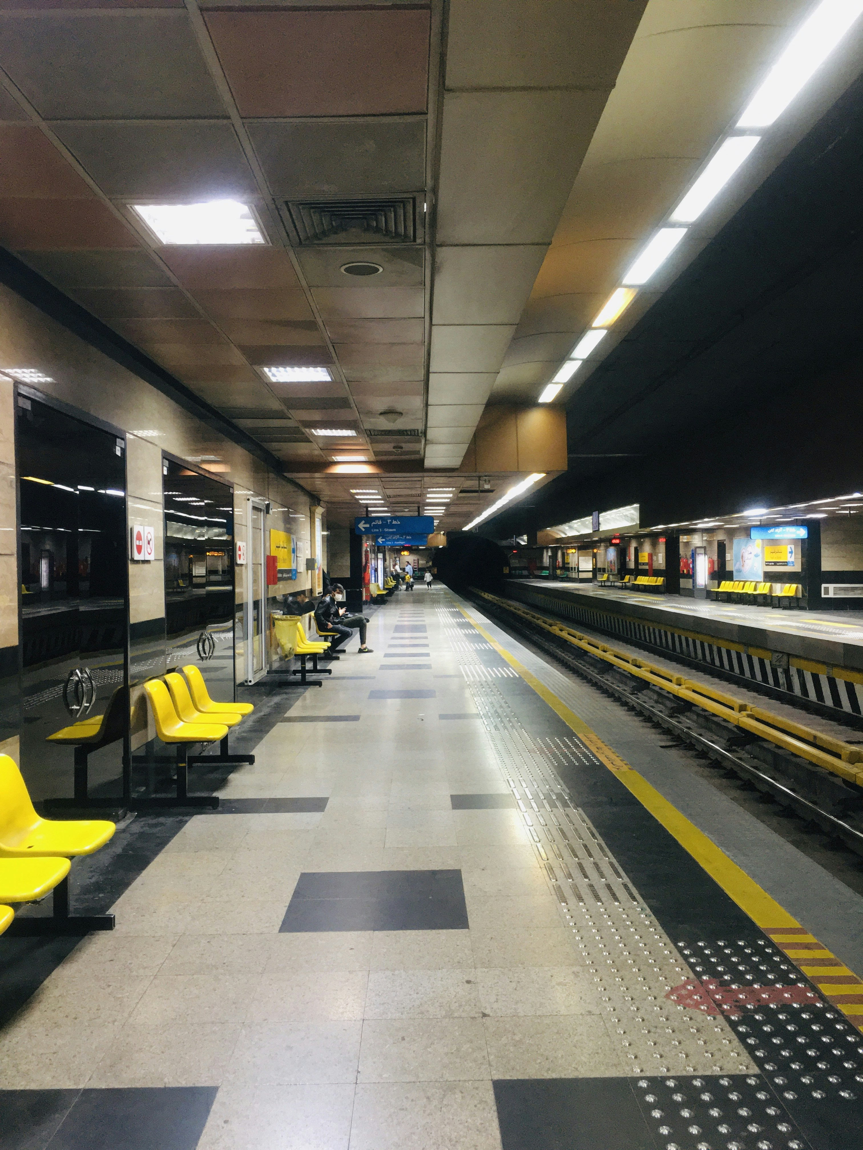 A group of people waiting at a train station photo – Free Train station ...