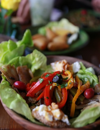 a plate of food with lettuce and peppers