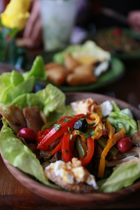 a plate of food with lettuce and peppers