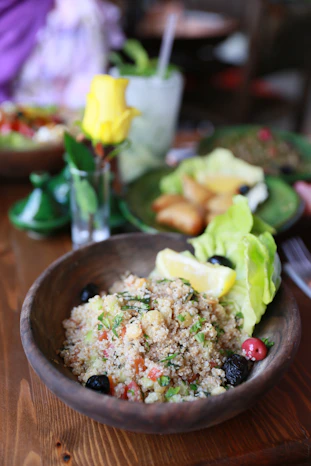 a bowl of food on a wooden table