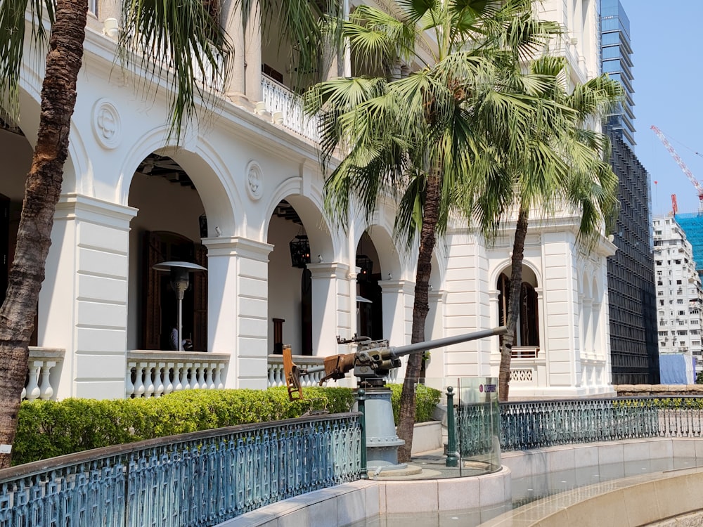 a statue of a cannon in front of a building