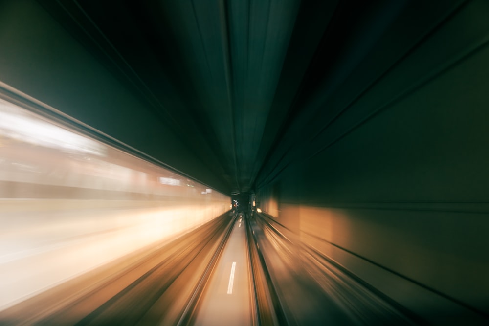 a blurry photo of a train going through a tunnel
