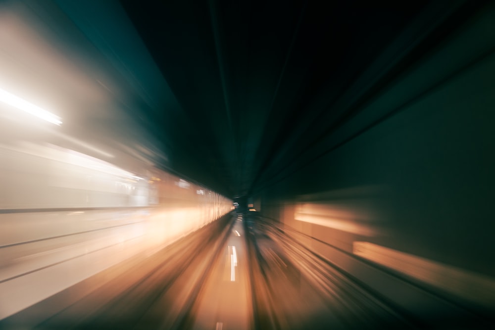 a blurry photo of a train going through a tunnel