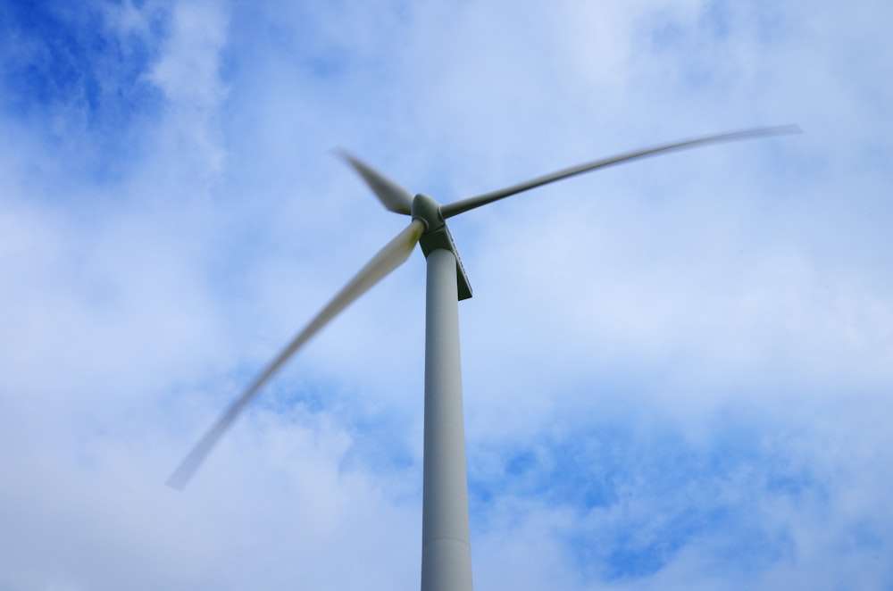 a wind turbine with a blue sky in the background