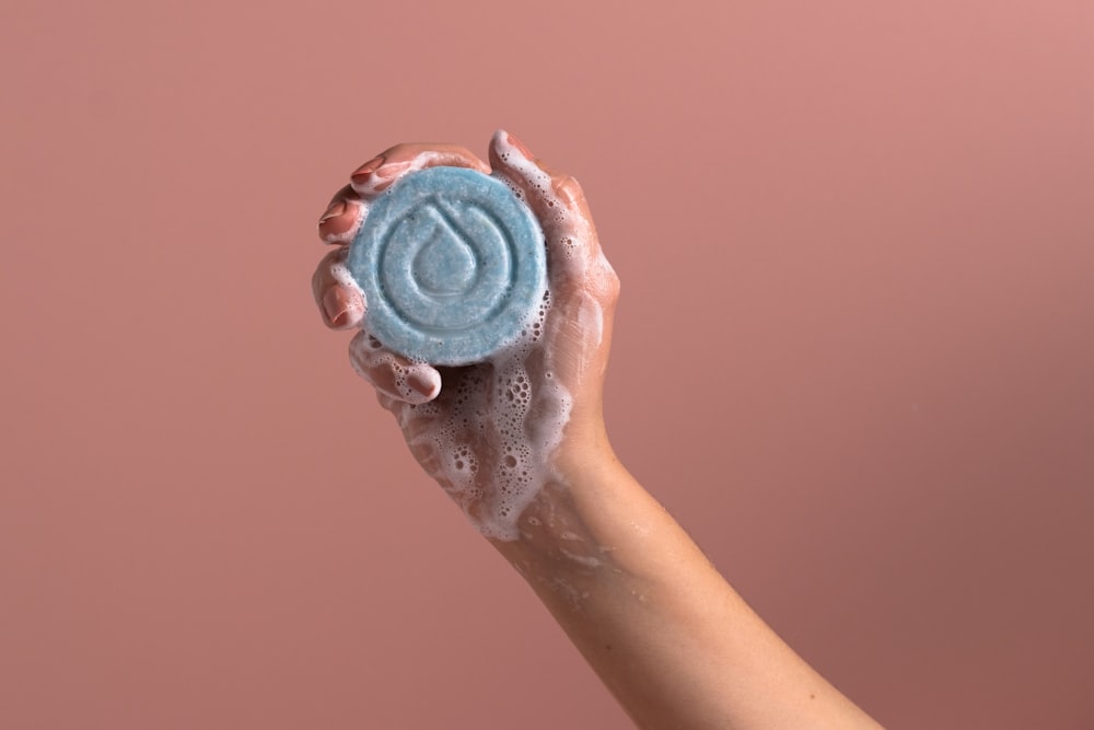 a person holding a soap bar in their hand