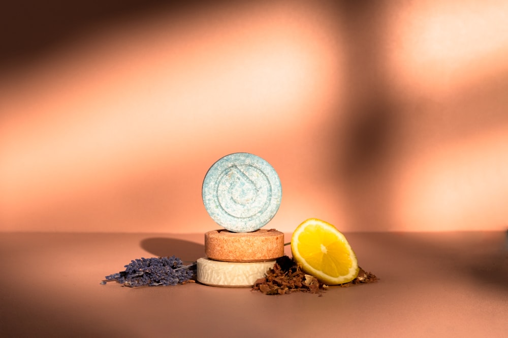 a table topped with a cup of coffee and a lemon