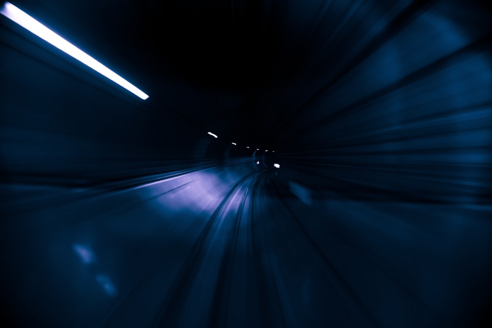 a blurry photo of a train going through a tunnel