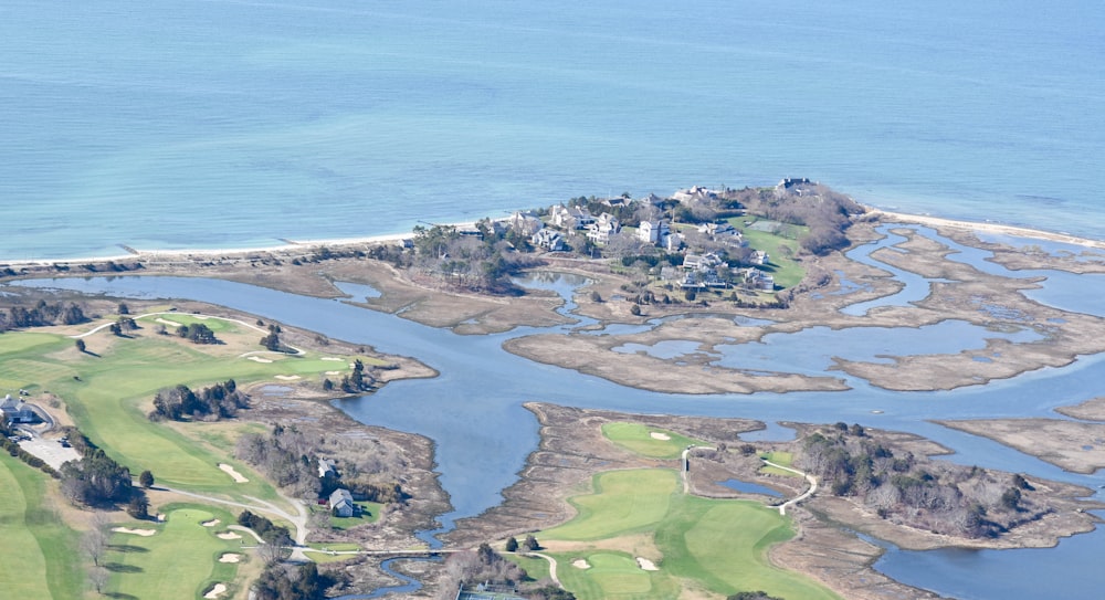 an aerial view of a golf course and water