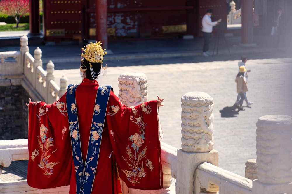 a man dressed in a red and blue costume