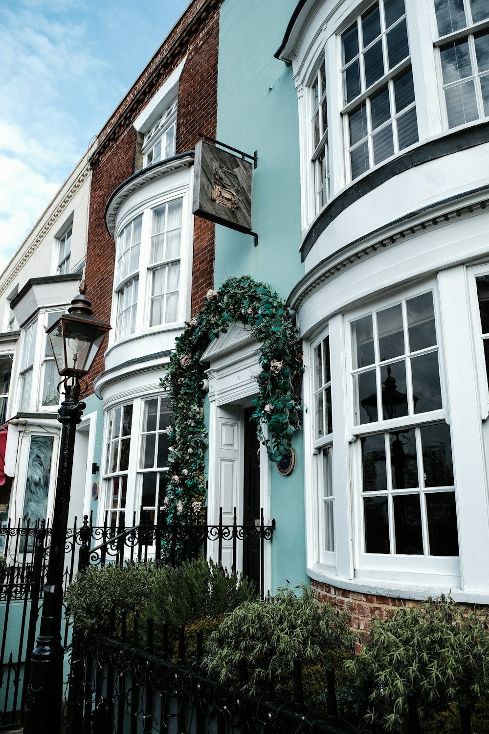 a blue building with a wreath on the front of it