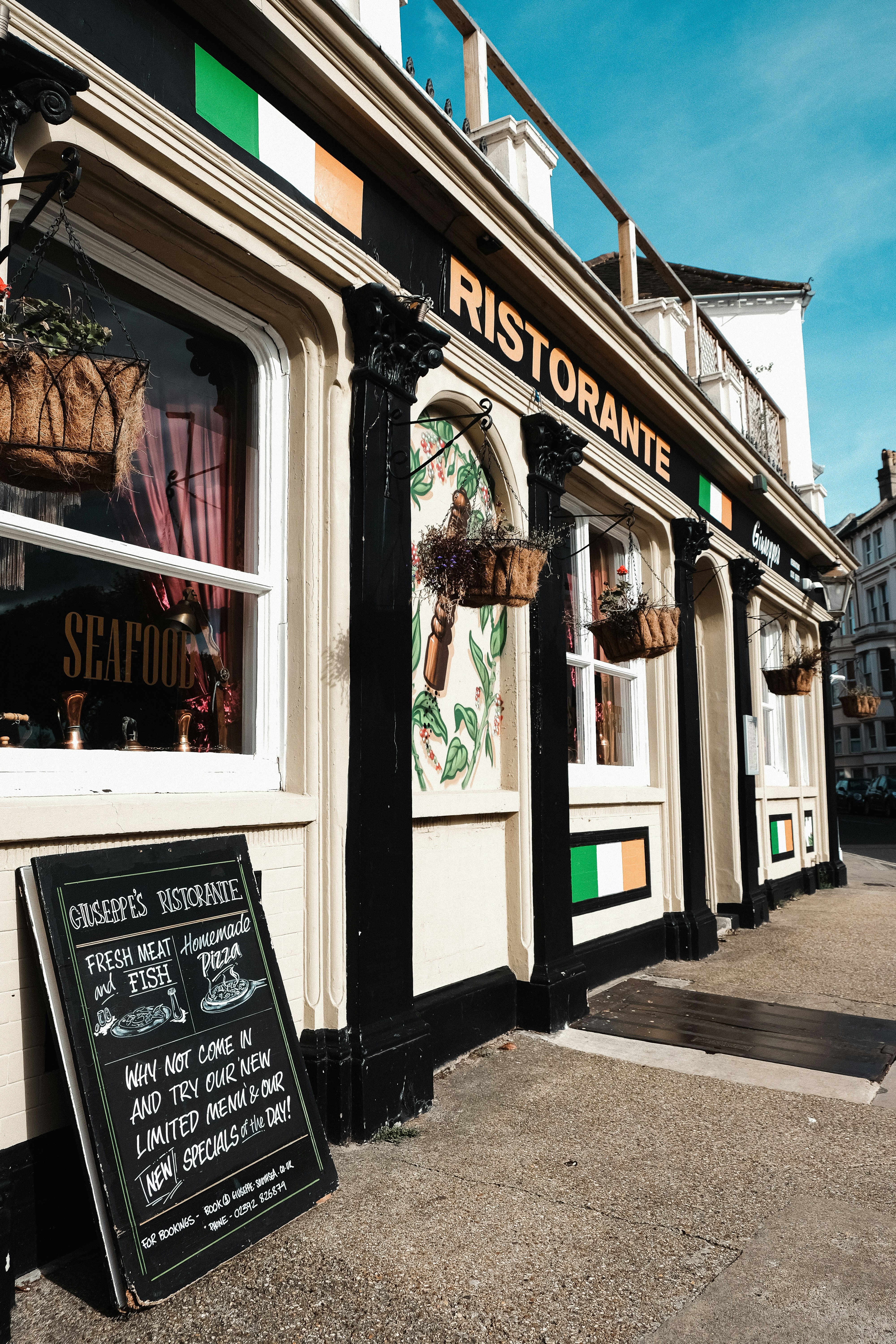a restaurant with a chalkboard sign in front of it