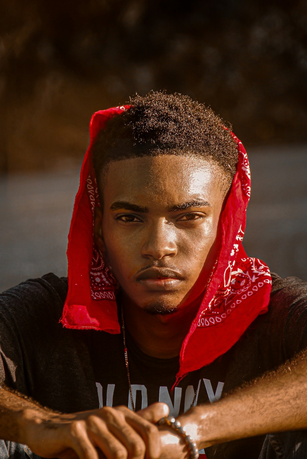 a young man with a red hoodie on