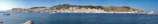 A panoramic view of a quiet coastal town in southern Brazil with fishing boats docked