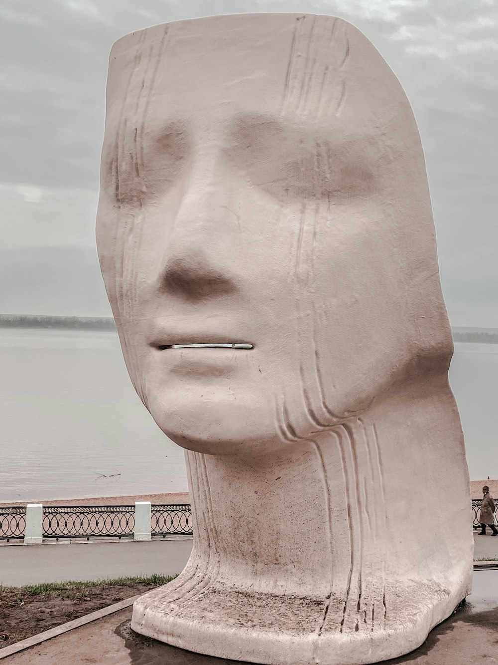 a statue of a person's head is shown in front of a body of