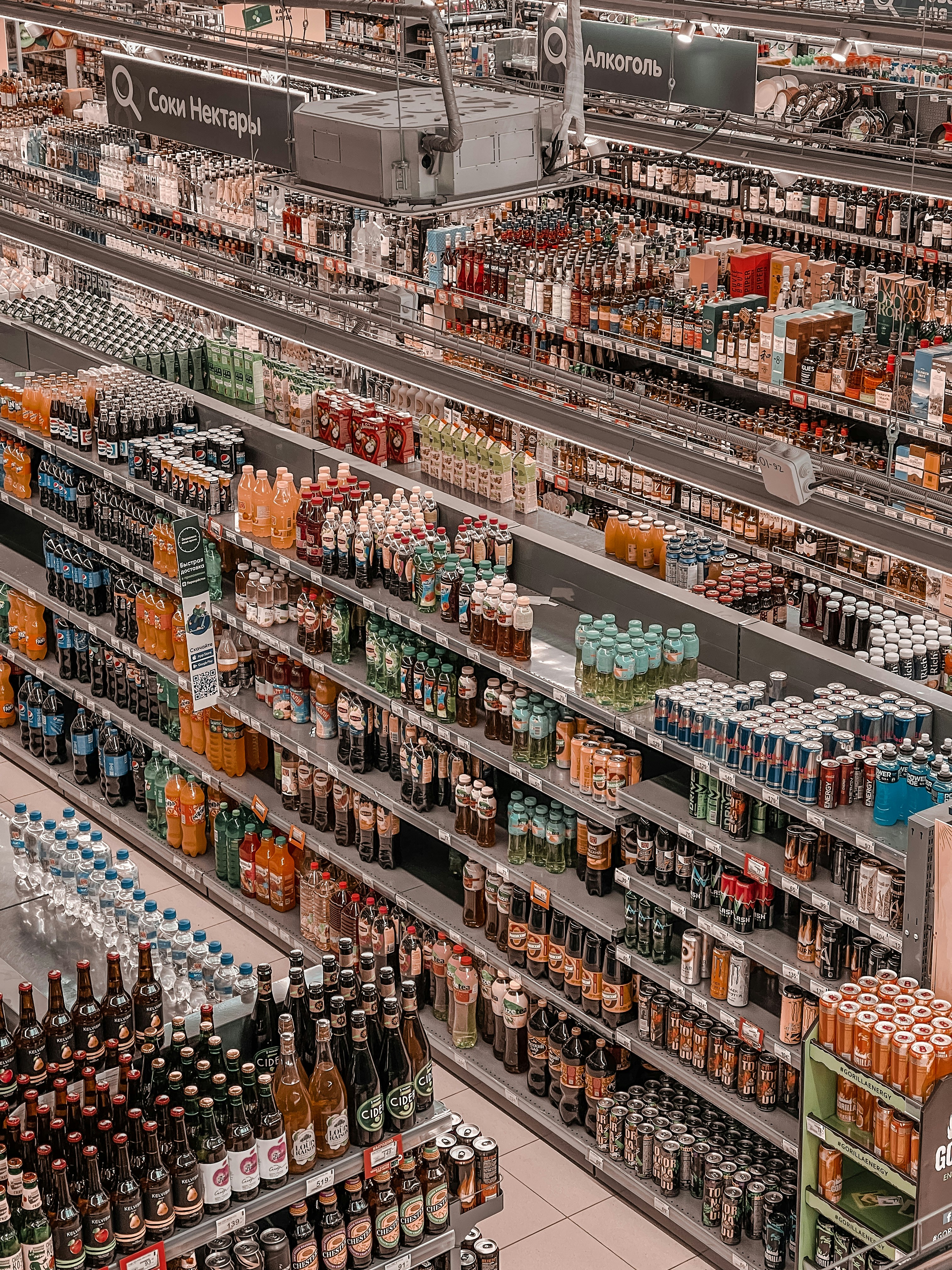 Warehouse aisle with shelves stocked with beverage products.