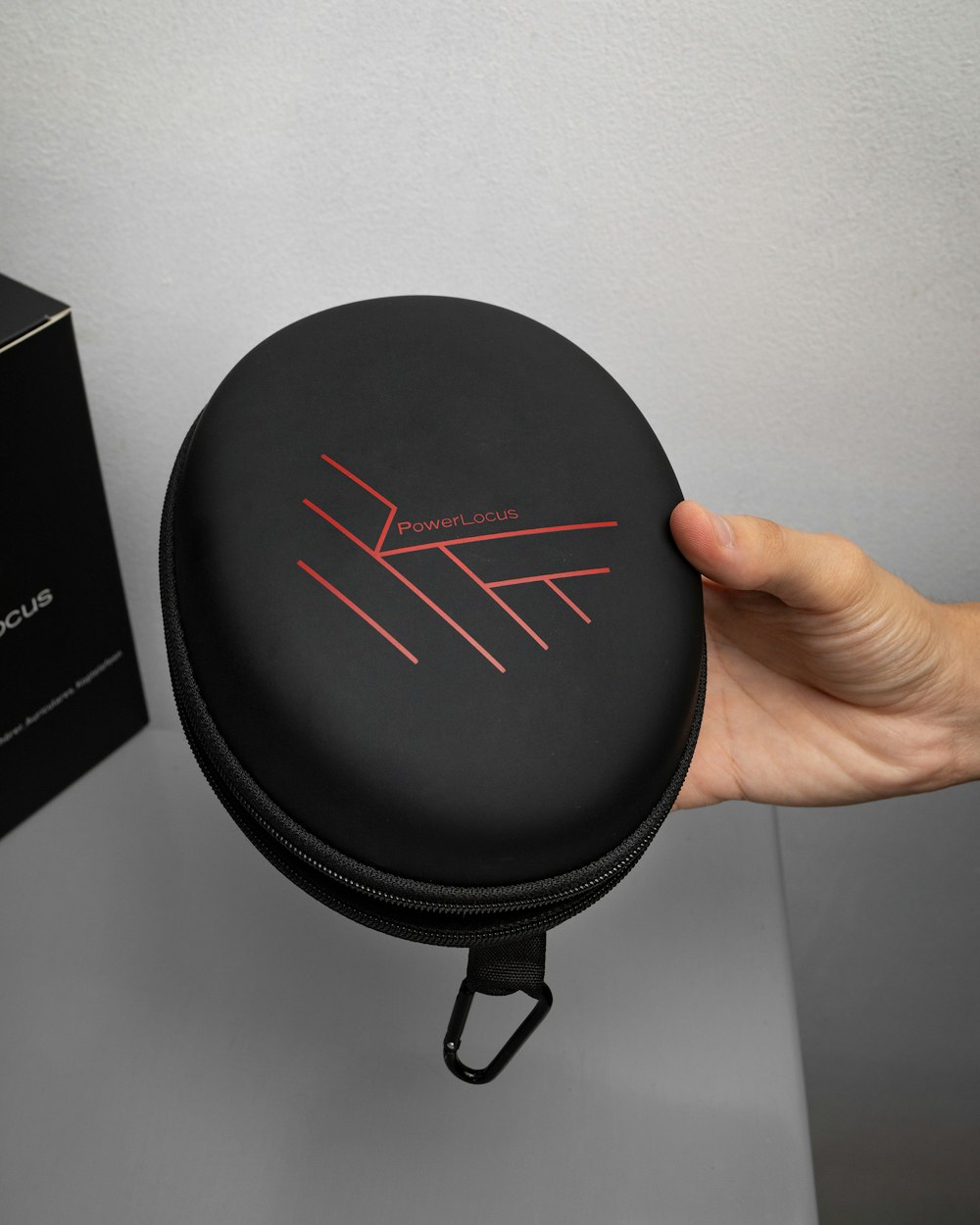 a person holding a black case with red lines on it