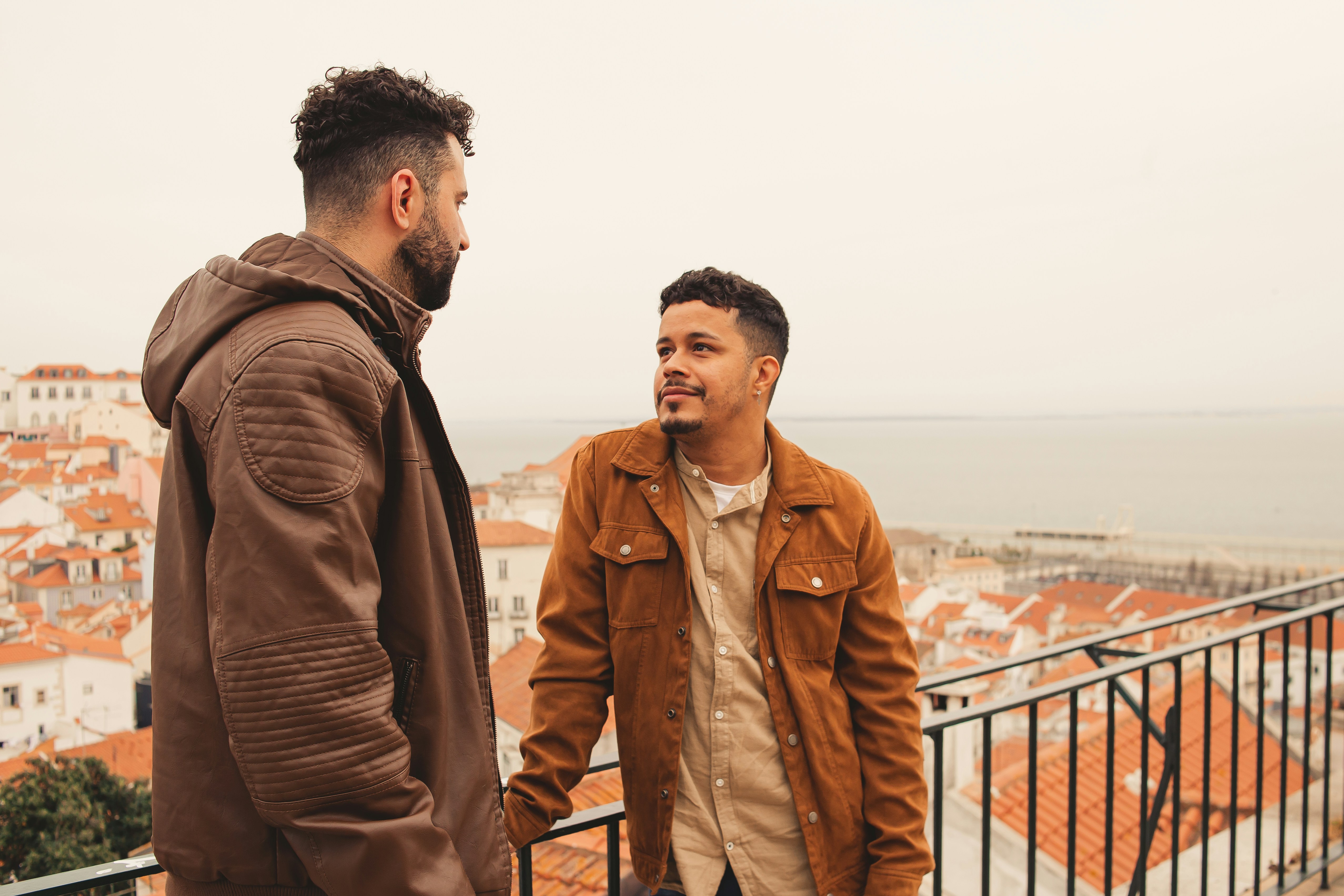 a couple of men standing next to each other, 