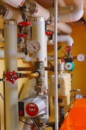 a room with a bunch of pipes and gauges