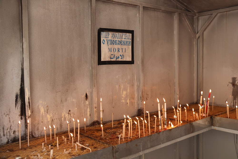 a bunch of candles that are on a table