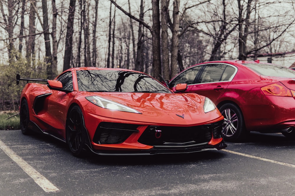 two red sports cars parked in a parking lot