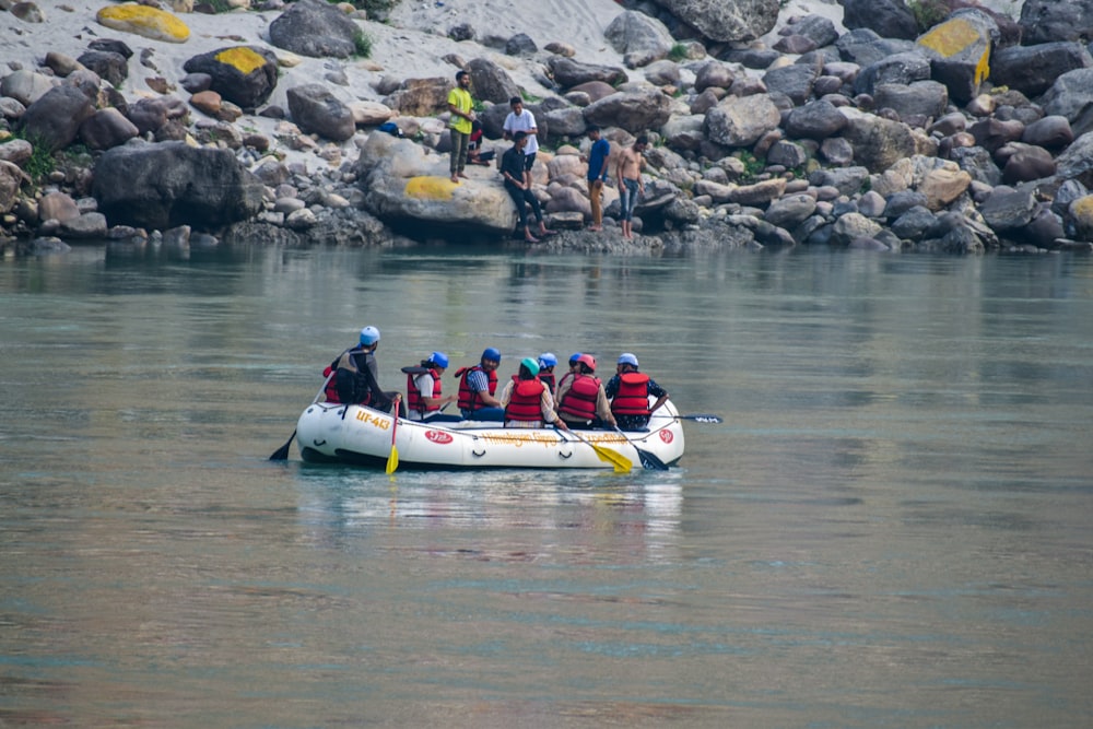 a group of people riding on the back of a white boat