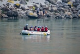 a group of people riding on the back of a white boat