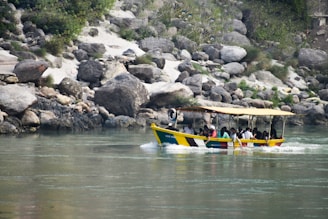 a group of people on a yellow boat in the water