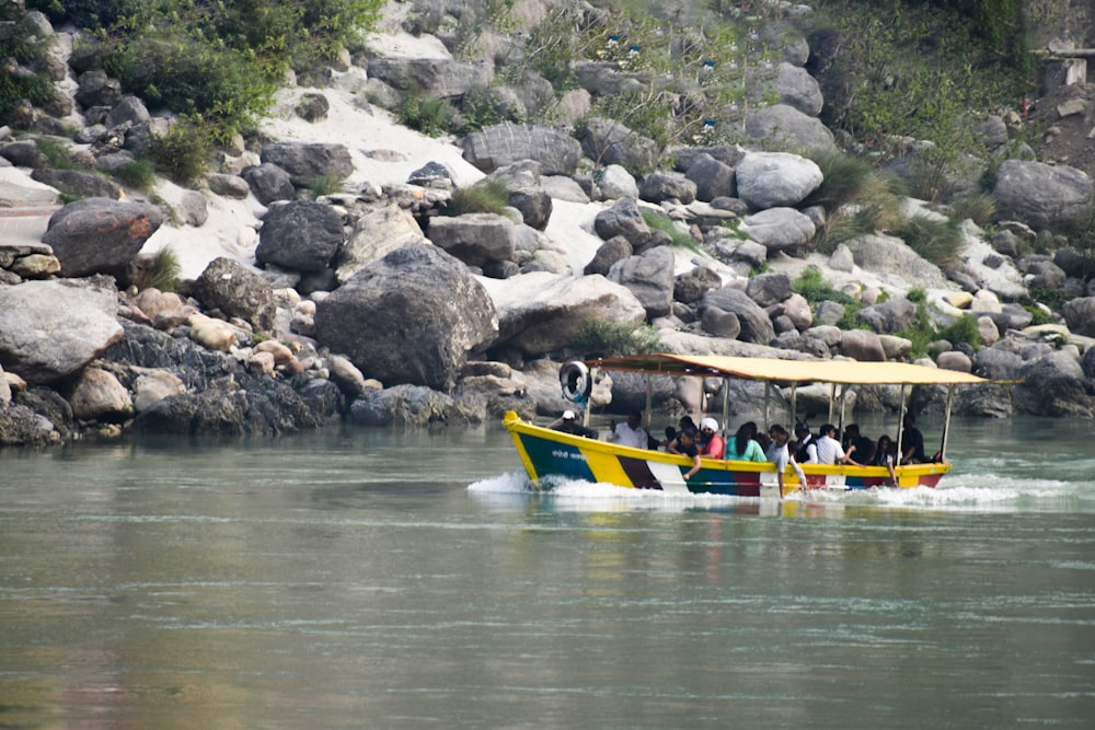 a group of people on a yellow boat in the water