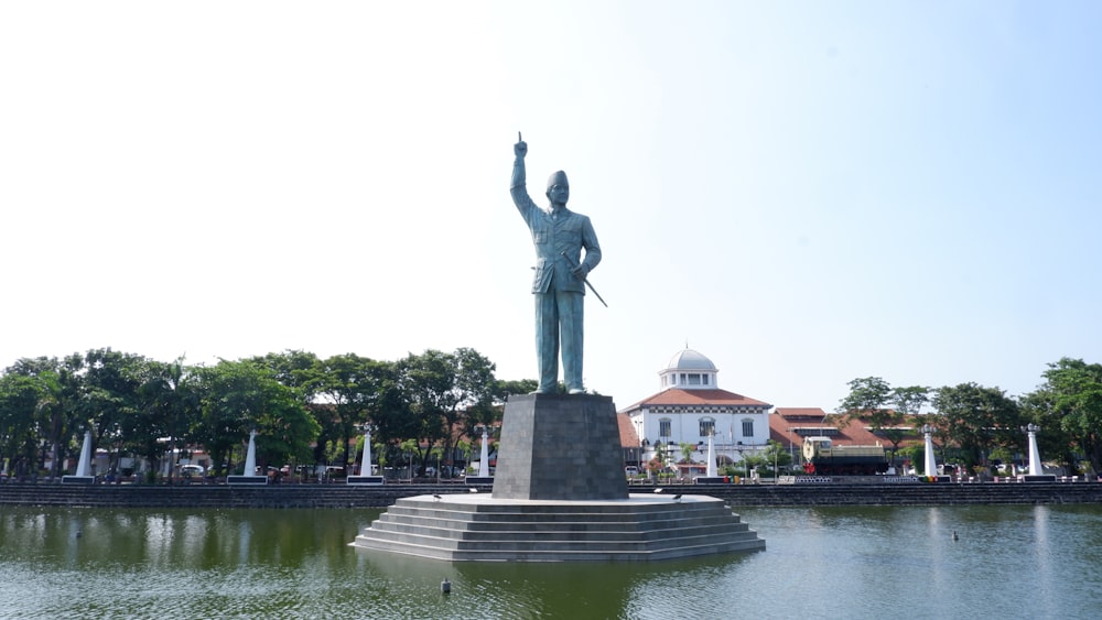 a statue of a man with his arms up in the air