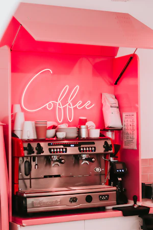 Mobile espresso cart with neon signage staged for an event