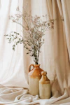 a couple of vases sitting on top of a bed