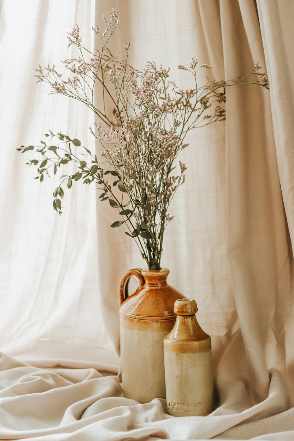 a couple of vases sitting on top of a bed