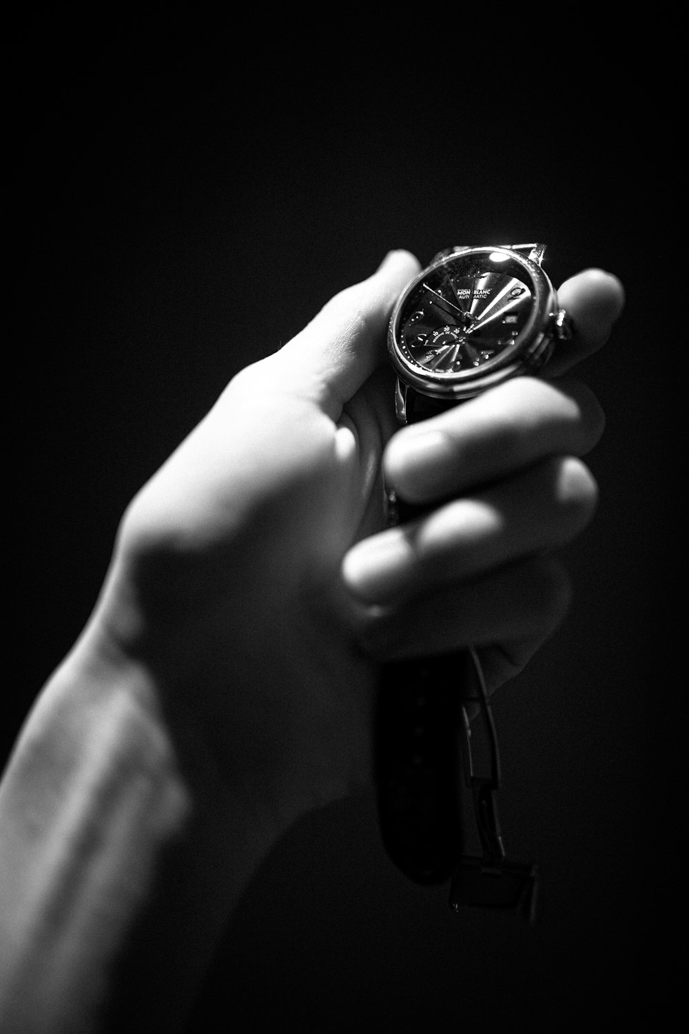 a person holding a watch in their hand