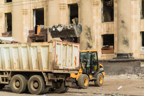 a dump truck parked in front of a building