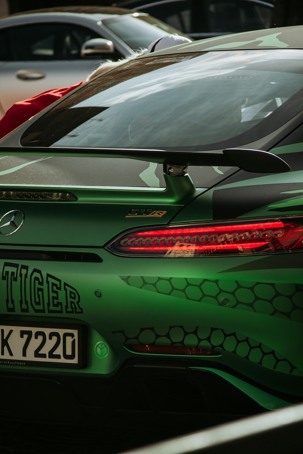 a green sports car parked in a parking lot