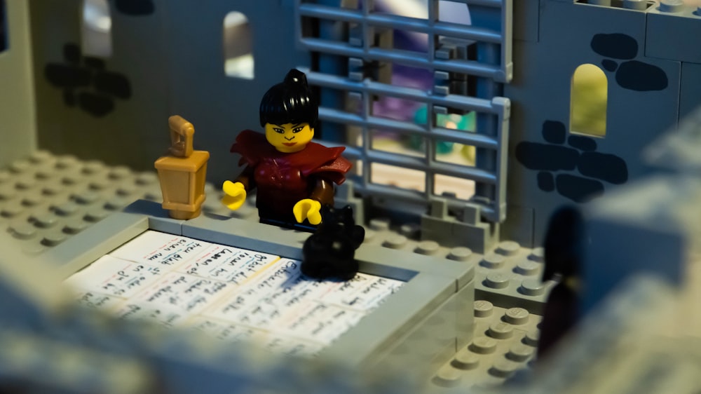 a lego scene with a man and a cat