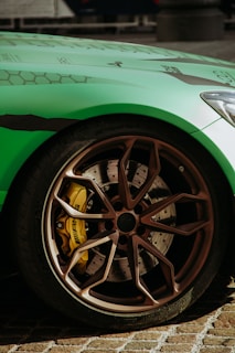 a green sports car parked on the side of the road