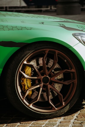 a green sports car parked on the side of the road
