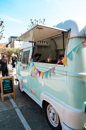a blue and white food truck parked in a parking lot