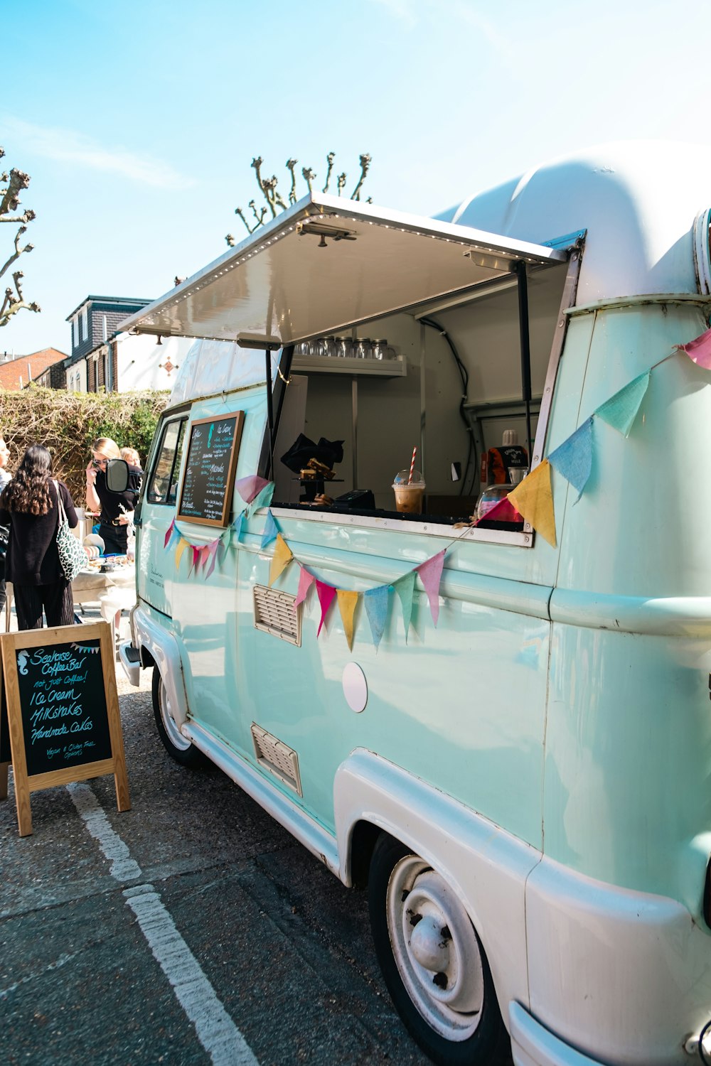 a blue and white food truck parked in a parking lot